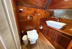 A wood panelled luxury bathroom on a boat