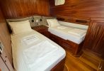 A private wood panelled luxury twin bedroom cabin